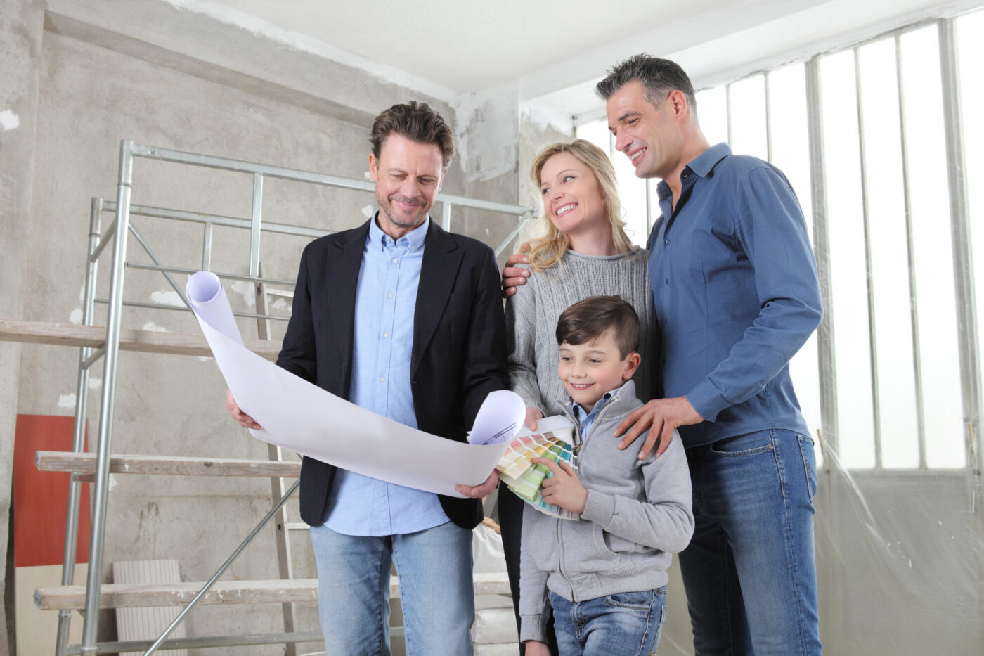 Architect showing house design plans to a family with child. meeting at interior construction site to talk about house appearance, interior decoration, home layout and wall colors